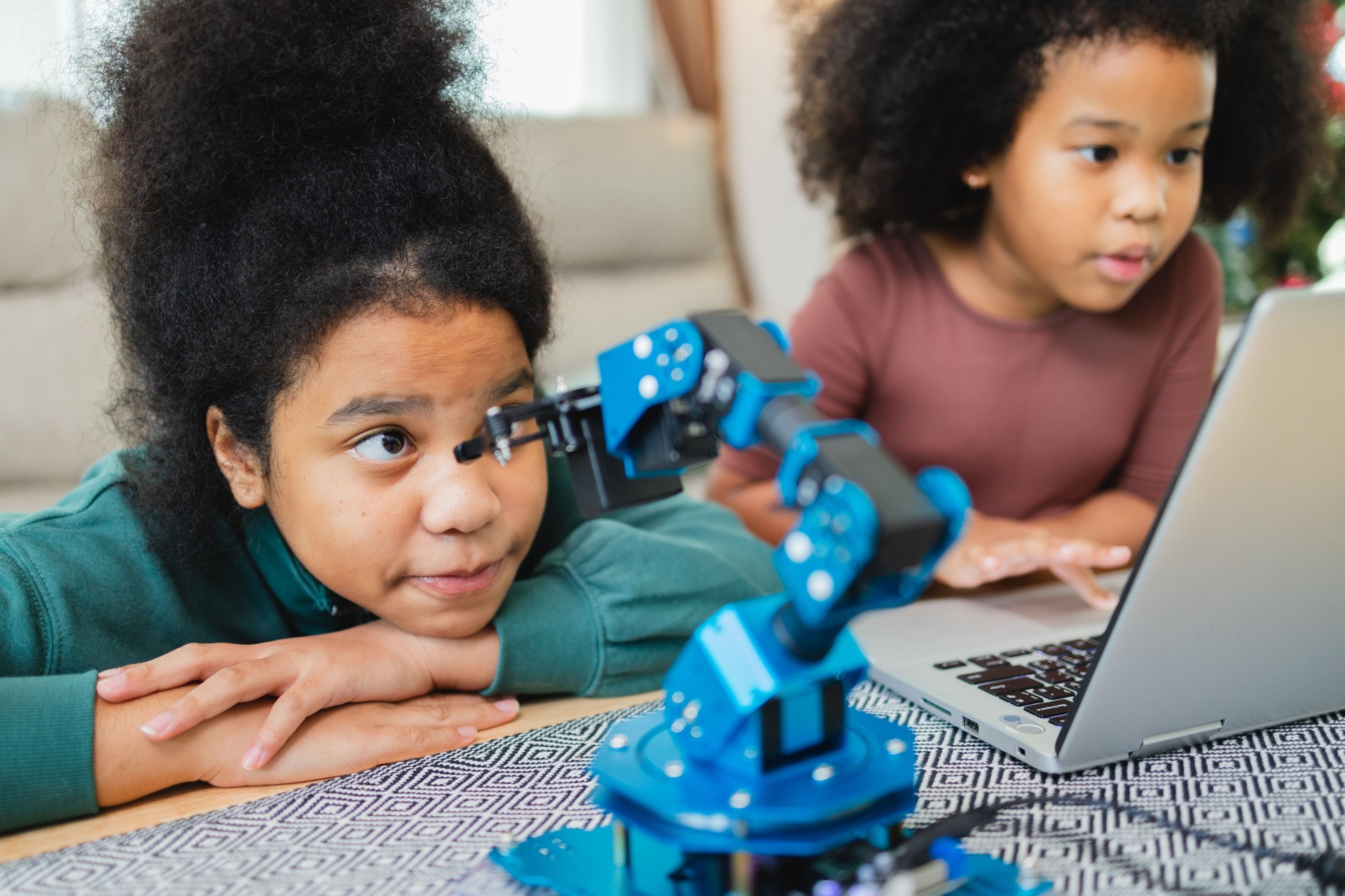 Two African American girls learned robot arms with a program computer. Innovative technology mechanical for Assistive Technology